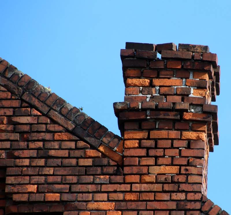 Signs Your Maywood Home Needs a Chimney Inspection Damaged chimney on an Maywood home showing cracks and missing mortar
